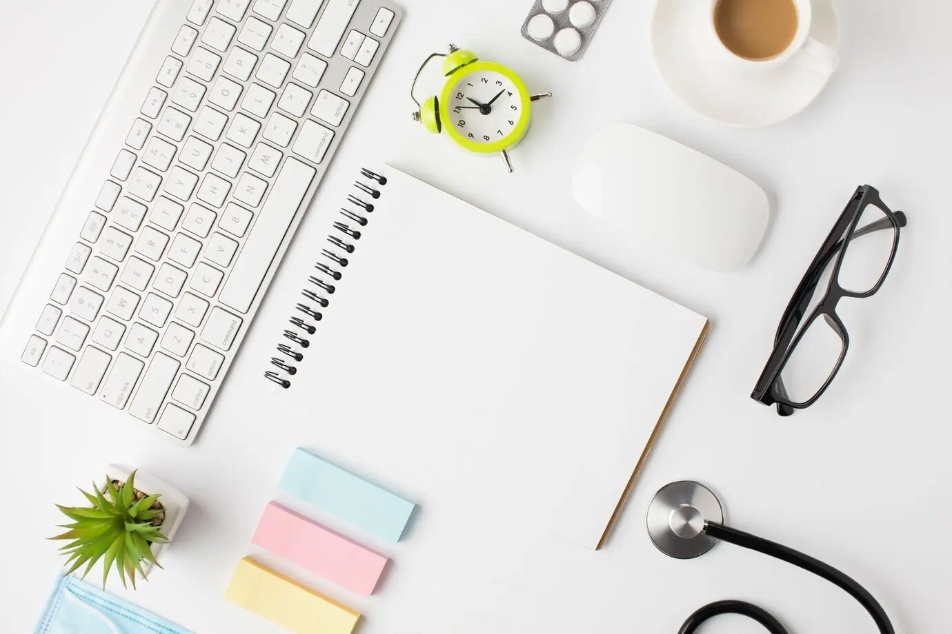 A beautiful arrangement of a clinic desk featuring a coffee cup and an alarm clock.